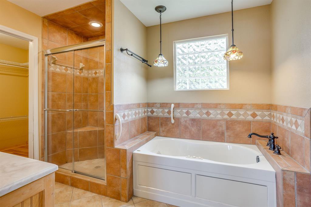 13350 Miller Road Azle, TX 76020 - Photo 26 of 40 a bathroom with a bathtub and shower