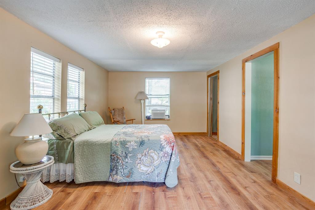 13350 Miller Road Azle, TX 76020 - Photo 10 of 40 a spacious bedroom with a bed and a window