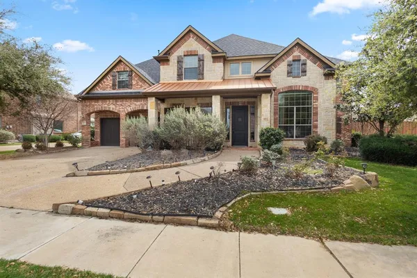a front view of a house with a yard outdoor seating and garage