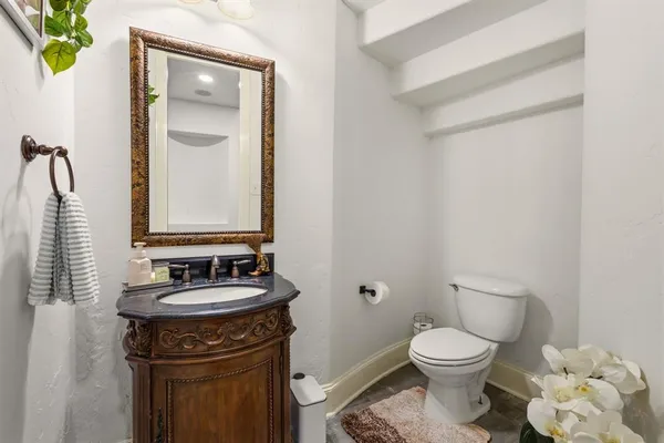 a bathroom with a toilet sink and mirror