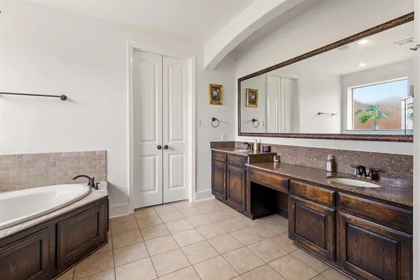 a large kitchen with a sink and dishwasher a stove with wooden floors