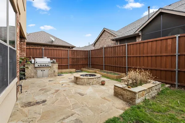 a view of a chairs and table in backyard