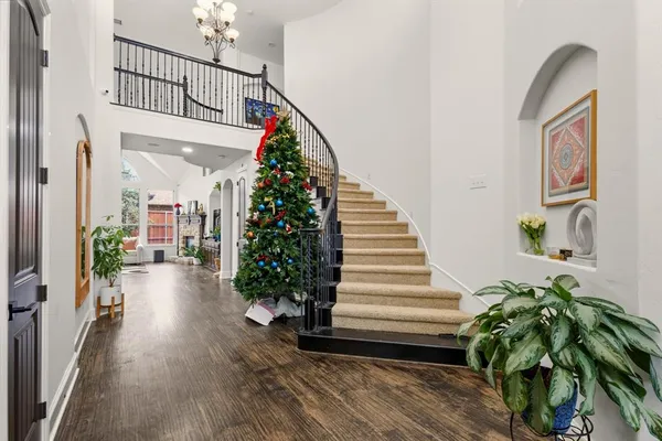 a view of entryway with stairs and wooden floor