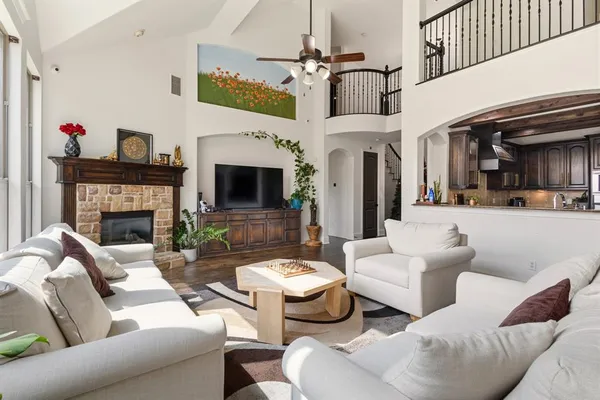 a living room with furniture a fireplace and a flat screen tv