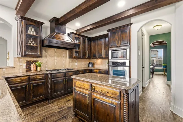 a kitchen with stainless steel appliances granite countertop a stove and a sink
