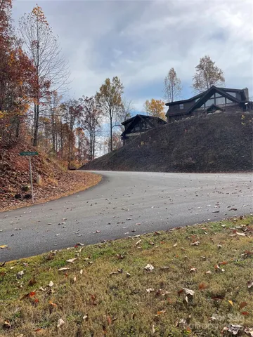 a view of a yard with wooden fence