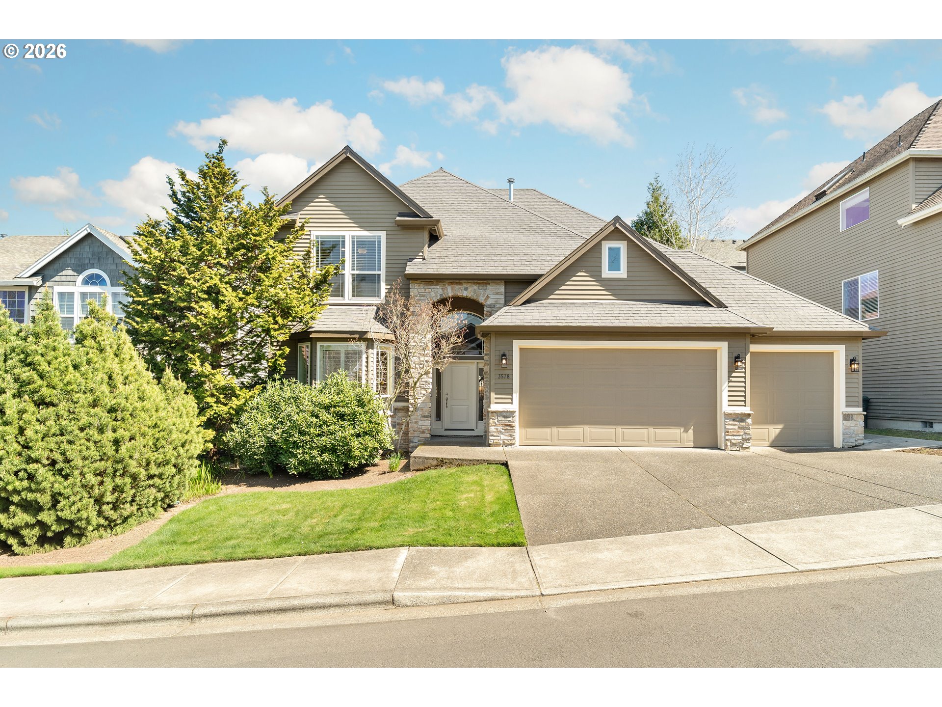 a front view of a house with a yard and garage