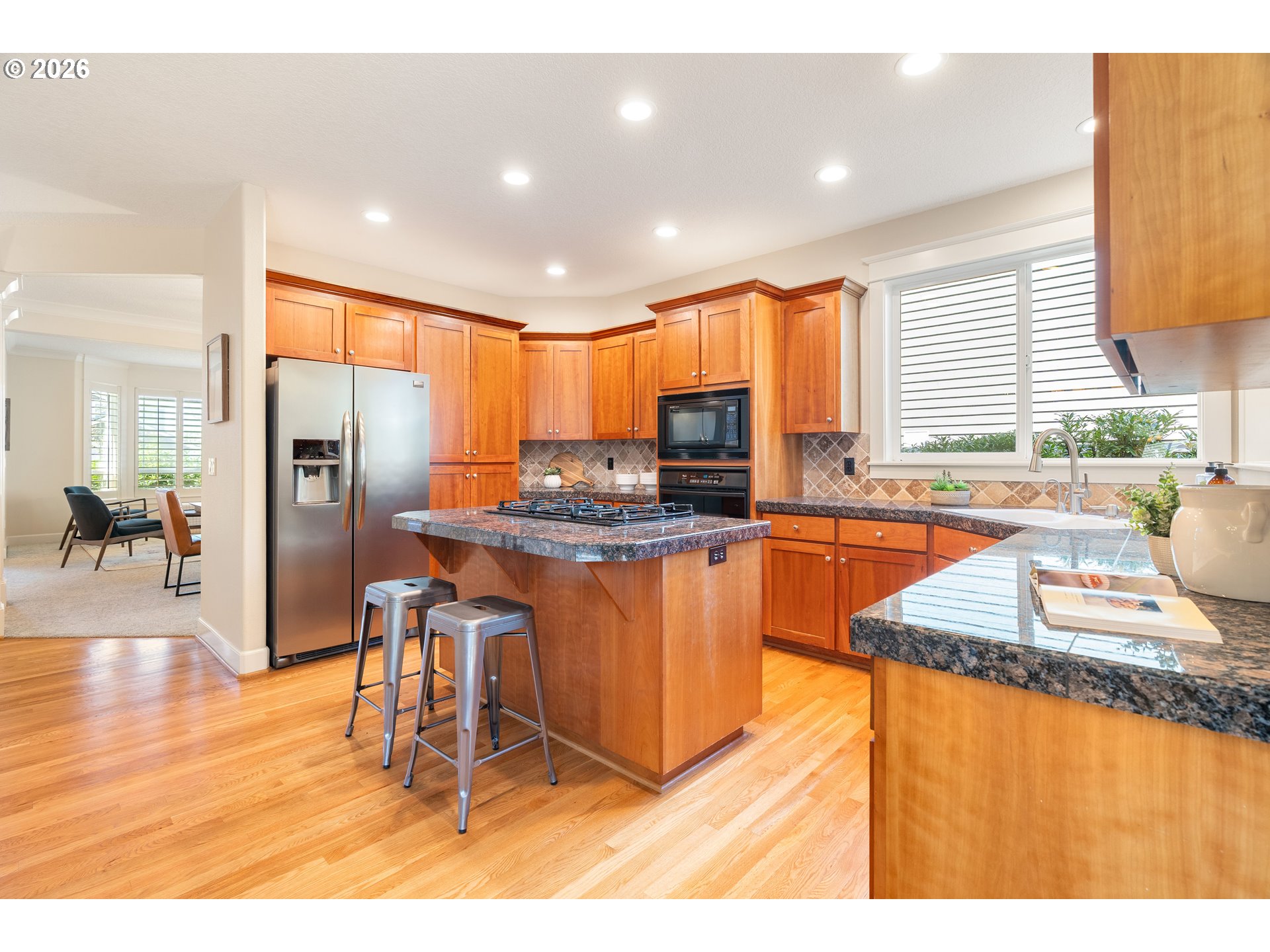 3578 Northwest Gerritz Terrace Portland, OR 97229 - Photo 11 of 47 a kitchen with stainless steel appliances granite countertop a refrigerator a sink a stove and island