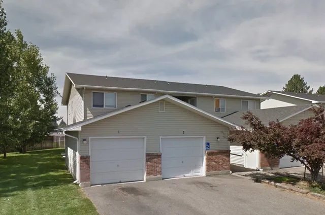 front view of house with a yard and a garage