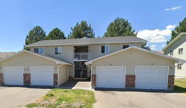 a view of a house with a yard and garage