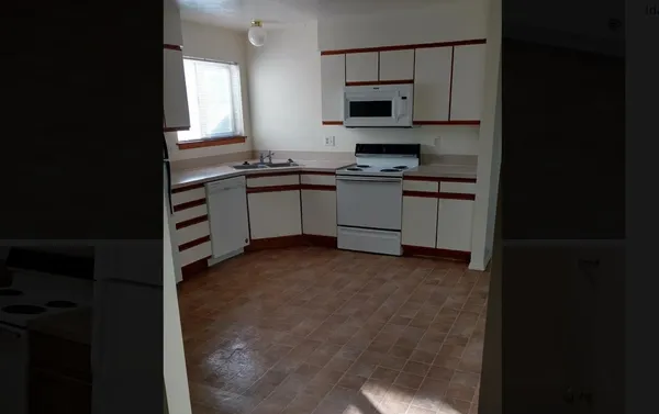 a kitchen with cabinets and appliances