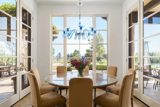 a view of a dining room with furniture a chandelier and wooden floor