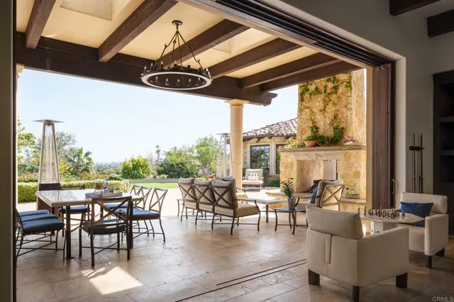a dining room with furniture water view and a floor to ceiling window