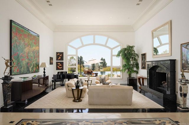 a living room with furniture large window and a fireplace