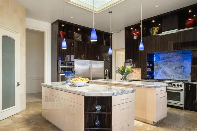 a kitchen with stainless steel appliances granite countertop a sink and a stove