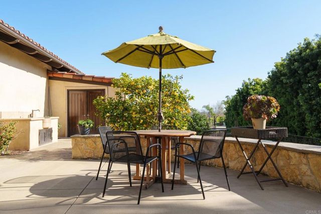 a patio with a patio table and chairs