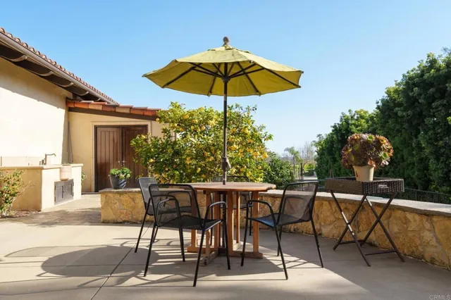 a patio with a patio table and chairs