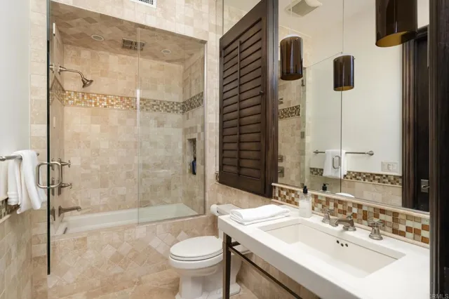 a bathroom with a sink toilet and shower