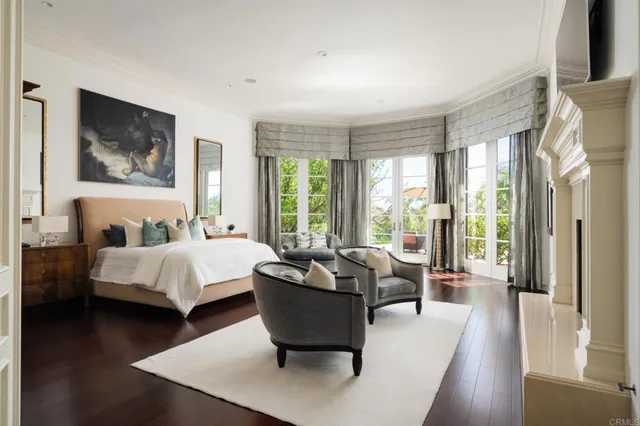 a spacious bedroom with a bed and a large window