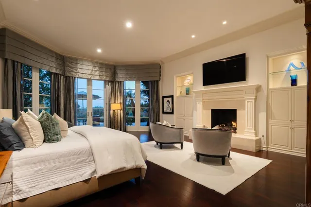 a bedroom with a large bed and a flat screen tv
