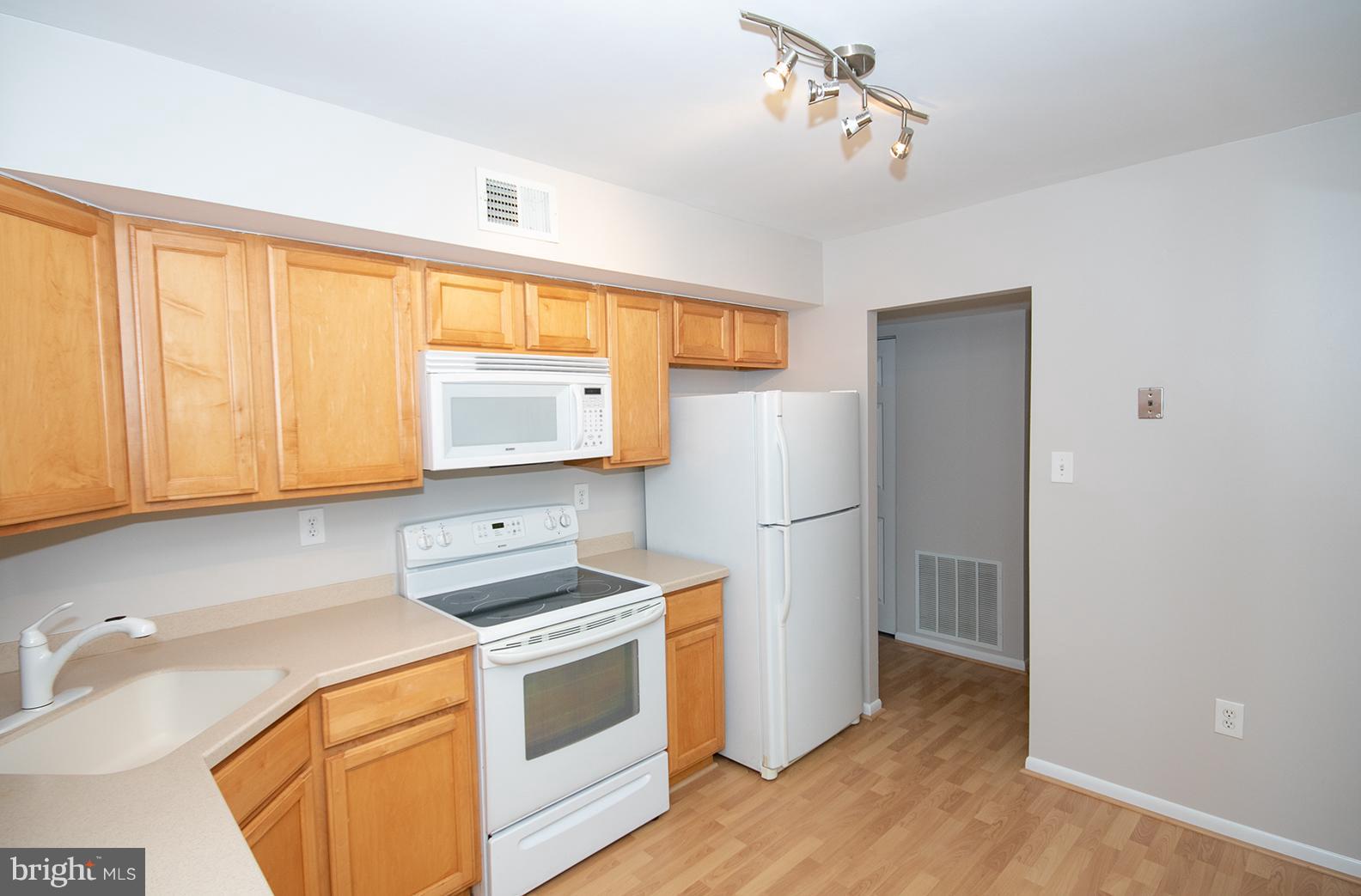 11727 Ledura Court, Unit 201 Reston, VA 20191 - Photo 16 of 29 a kitchen with a refrigerator sink and cabinets
