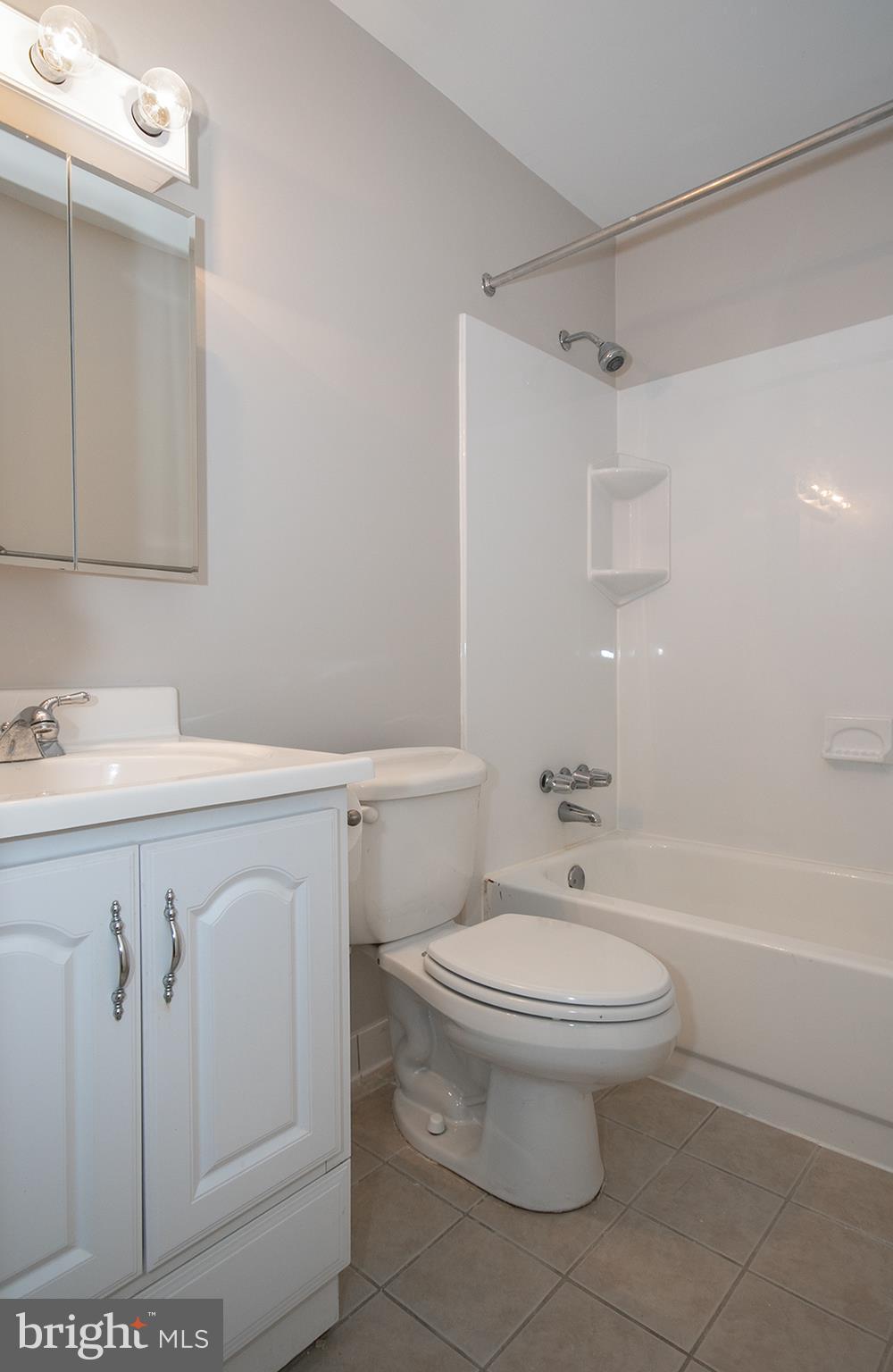 11727 Ledura Court, Unit 201 Reston, VA 20191 - Photo 24 of 29 a bathroom with a sink a toilet and shower