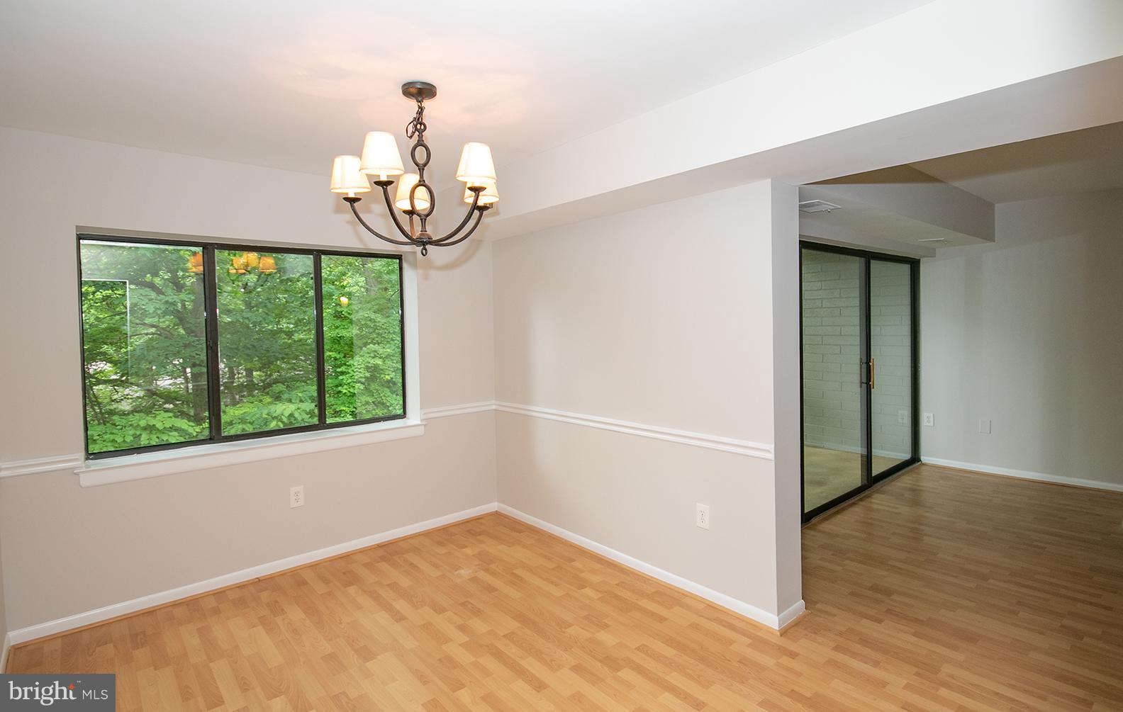 11727 Ledura Court, Unit 201 Reston, VA 20191 - Photo 9 of 29 an empty room with wooden floor fan and windows