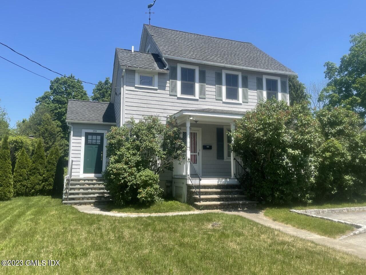 37 Orchard Street, Unit B Cos Cob, CT 06807 - Photo 1 of 15 a front view of a house with a yard
