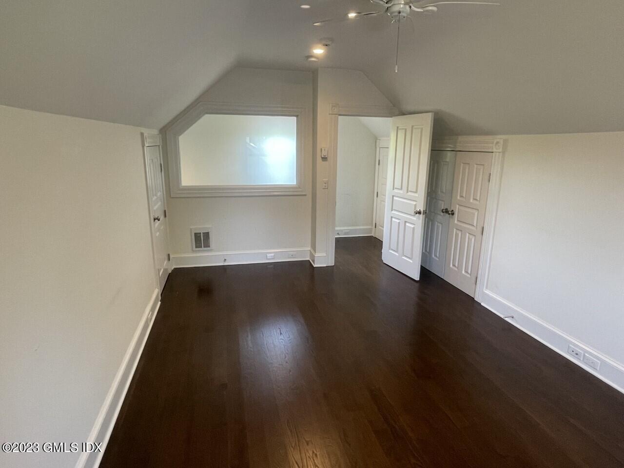 37 Orchard Street, Unit B Cos Cob, CT 06807 - Photo 11 of 15 an empty room with wooden floor and windows