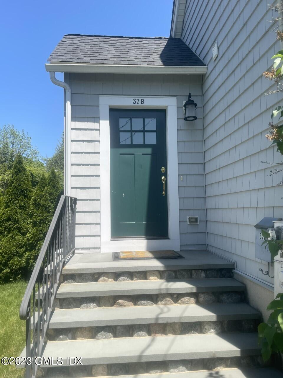 37 Orchard Street, Unit B Cos Cob, CT 06807 - Photo 2 of 15 a view of a house with a door and a potted plant