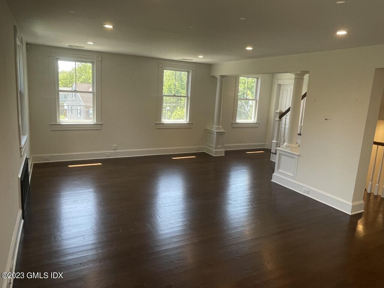 37 Orchard Street, Unit B Cos Cob, CT 06807 - Photo 7 of 15 an empty room with wooden floor and windows