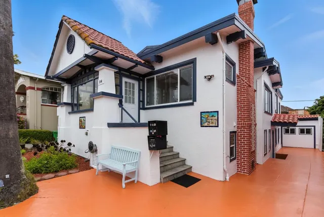a view of a dining room with furniture a chandelier and wooden floor