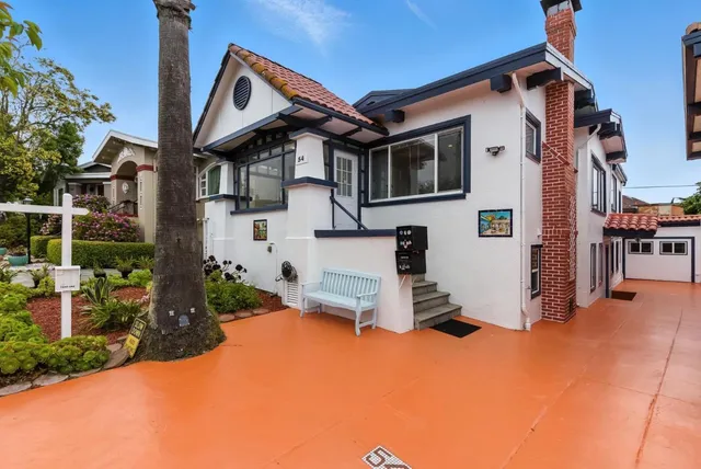 a view of a dining room with furniture wooden floor and chandelier