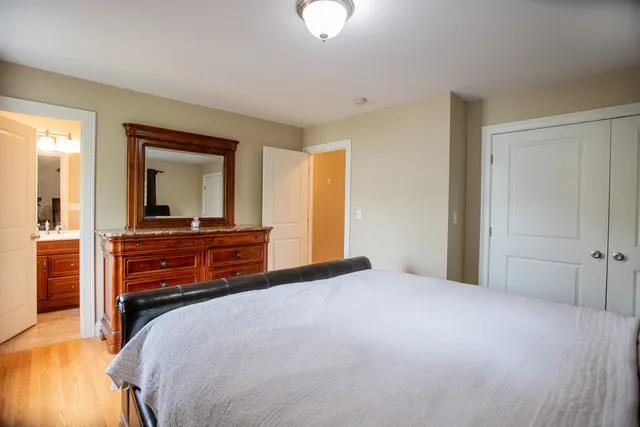 a bedroom with a bed and wooden floor