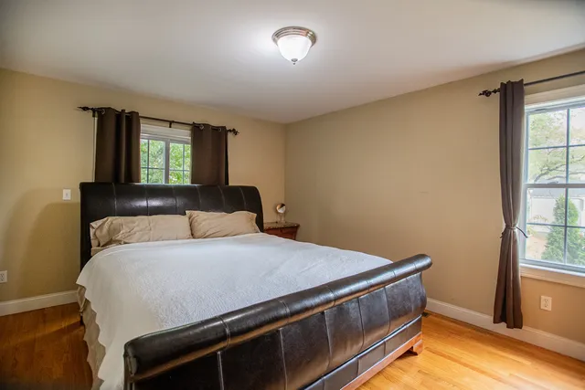 a bedroom with a bed and a lamp