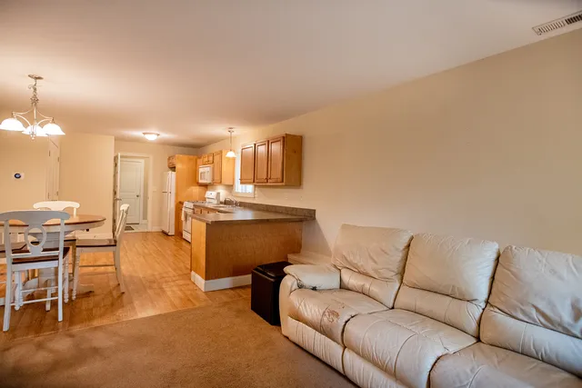 a kitchen with stainless steel appliances granite countertop wooden cabinets stove top oven and sink