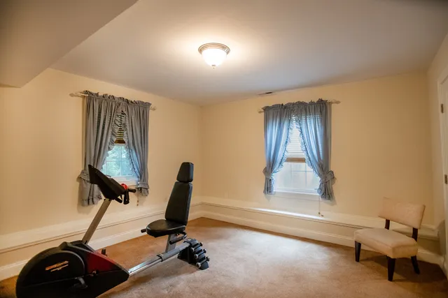 a living room with furniture a fireplace and a kitchen view