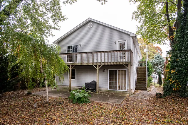 a bathroom with a granite countertop toilet a sink and a mirror