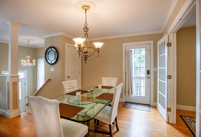 a dining room with furniture and wooden floor