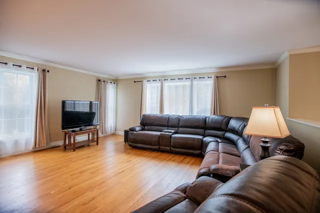 a view of a dining room with furniture window and wooden floor