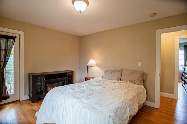 a kitchen with stainless steel appliances granite countertop a refrigerator a stove top oven and a center island with wooden floor