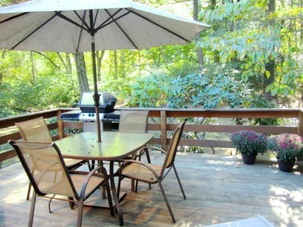 27 Joyce Road Framingham, MA 01701 - Photo 9 of 23 a backyard of a house with table and chairs under an umbrella