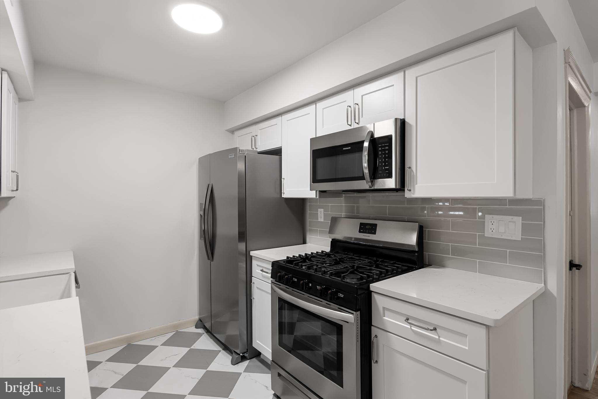 42 Trowbridge Lane, Unit DD Clementon, NJ 08021 - Photo 3 of 28 a kitchen with a stove microwave and refrigerator
