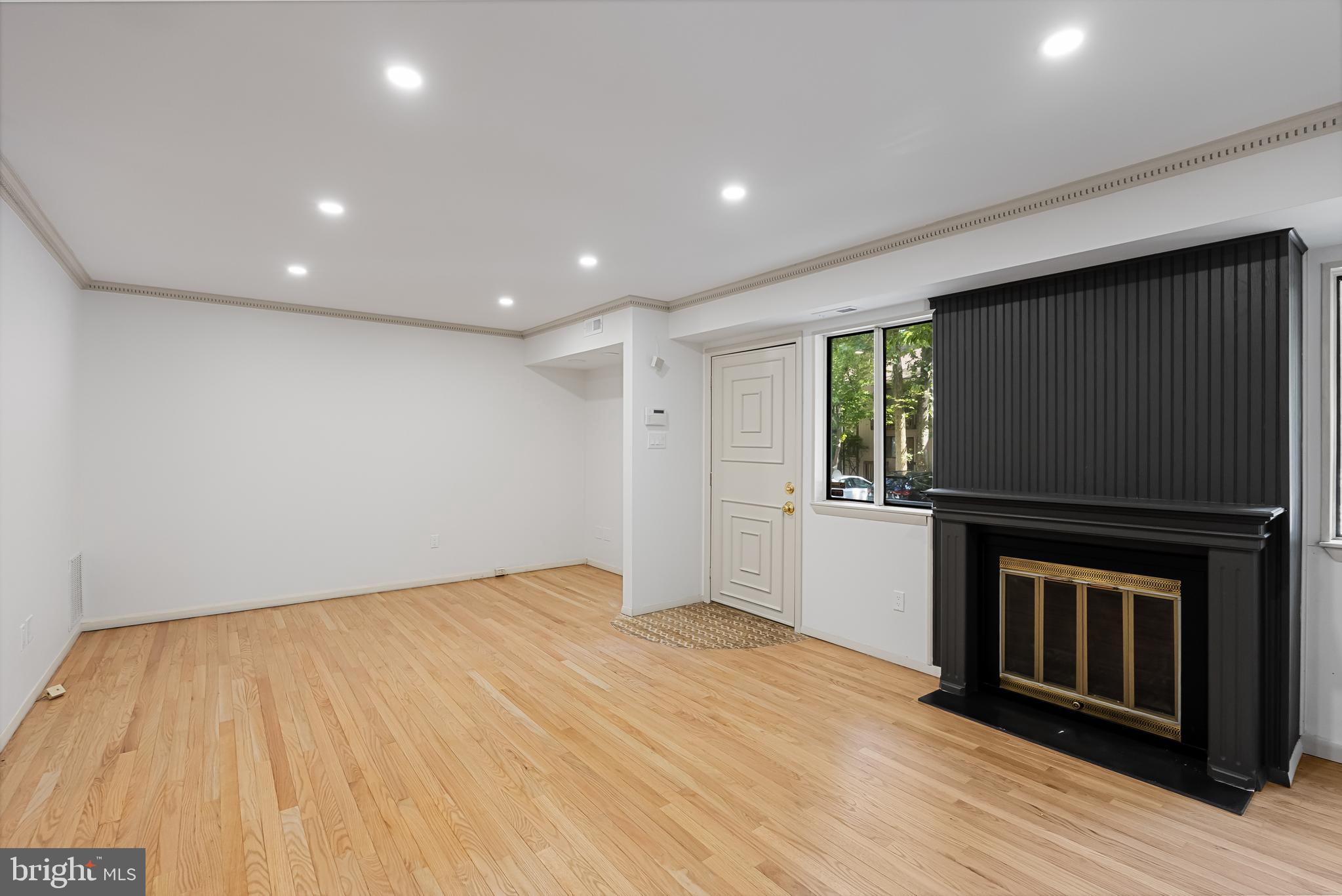 42 Trowbridge Lane, Unit DD Clementon, NJ 08021 - Photo 10 of 28 a view of empty room with wooden floor and fireplace