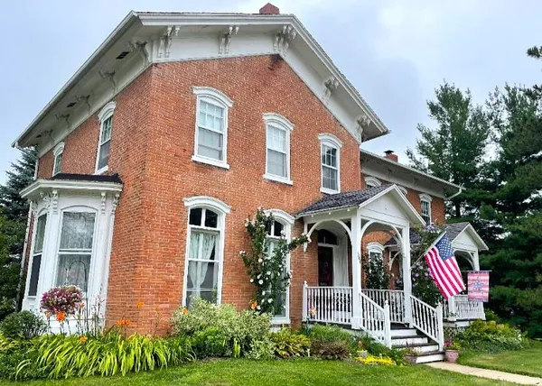 a front view of a house with garden