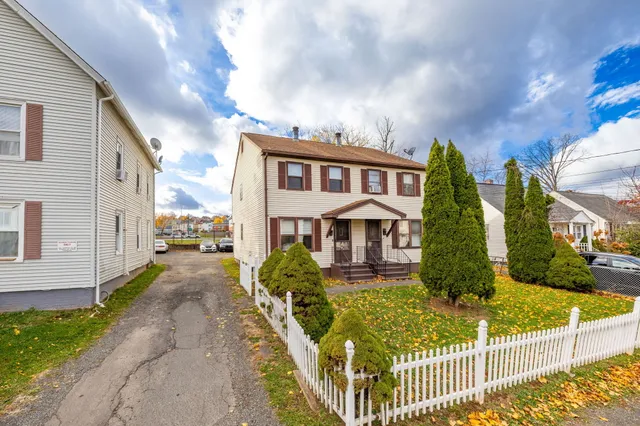 a view of a house with iron fence