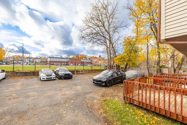 a view of a street with cars parked