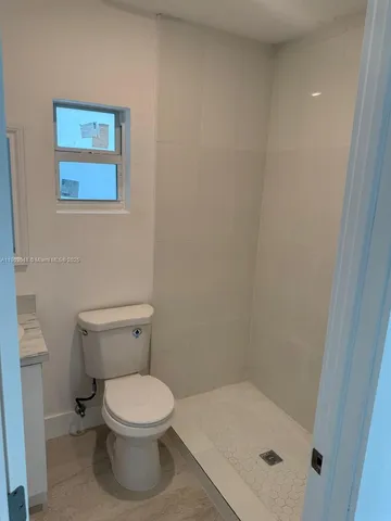 a white toilet sitting next to a bathroom sink