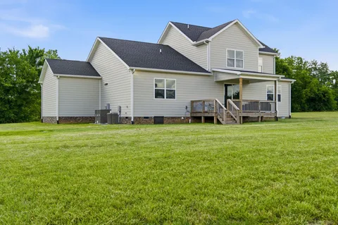 a front view of house with yard and green space