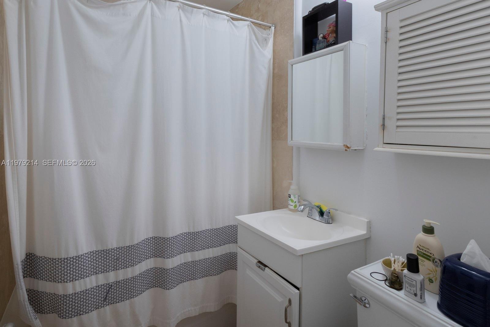 2710 Southwest 28th Court Miami, FL 33133 - Photo 13 of 19 a bathroom with a sink and a mirror